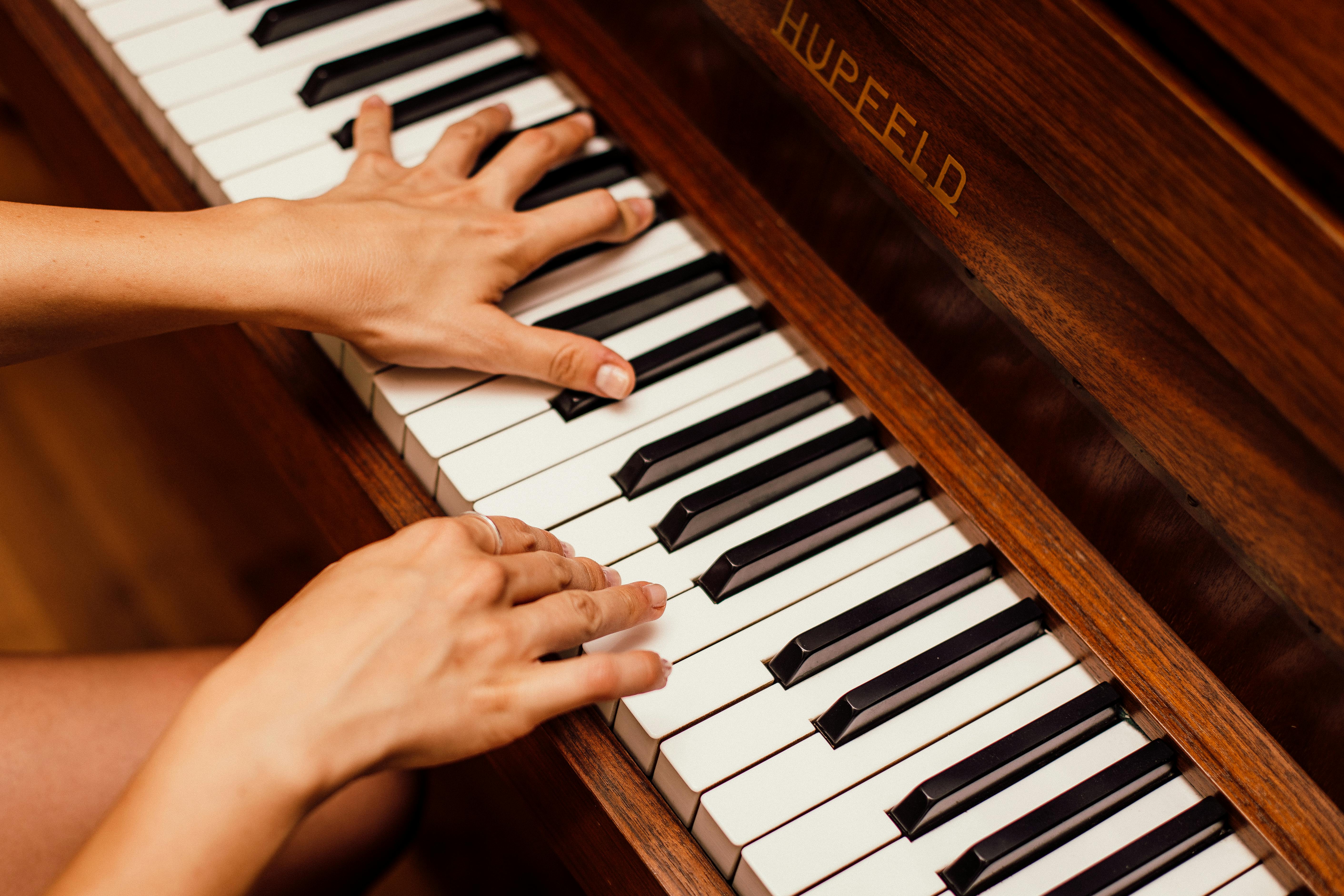 Professional piano technician working on piano keys
